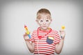 Cute boy playing doctor. Toy syringe, glasses and phonendoscope. Portrait Royalty Free Stock Photo