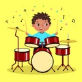 Cute boy playing the drum on yellow background Royalty Free Stock Photo