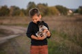 Cute boy playing with his dog in the meadow. Little puppy jack russel terrier on the walk with owner Royalty Free Stock Photo