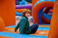 Cute boy playing on inflatable bounce house in entertainment center Royalty Free Stock Photo