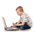 Cute boy playing with laptop