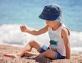 Cute boy, playing with pebbles on the beach Royalty Free Stock Photo