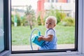 Cute boy, playing with plastic toy hoover Royalty Free Stock Photo