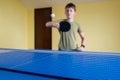 Cute boy playing table tennis indoors. Ping pong Royalty Free Stock Photo