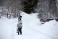 Cute boy playing with teddy bear in the snow, winter time. Little toddler playing with toys on a snowy day Royalty Free Stock Photo