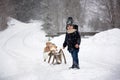 Cute boy playing with teddy bear in the snow, winter time. Little toddler playing with toys on a snowy day Royalty Free Stock Photo