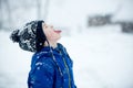 Cute boy playing with teddy bear in the snow, winter time. Little toddler playing with toys on snowy day Royalty Free Stock Photo