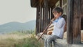 Cute boy playing on woodwind wooden flute - ukrainian sopilka. Folk music concept. Musical instrument. Kid in