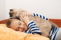 Cute boy plays with a cat at home. Happy kid hugging his cat Royalty Free Stock Photo