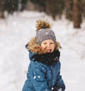 Cute boy plays with snow in a beautiful snow park in winter Royalty Free Stock Photo