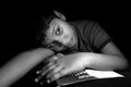 Cute boy portrait. Child laid on books during his study time and thinking something. Royalty Free Stock Photo