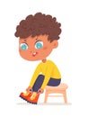 Cute boy putting on boots, isolated adorable little kid sitting on chair to put on shoes