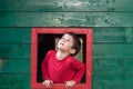 Cute boy on red framed window Royalty Free Stock Photo