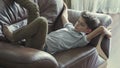 Cute boy relax on armchair