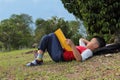 A cute boy relaxing on a park reading a book