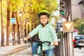 Cute boy riding his bike on green signal of lights