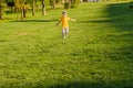 Cute boy running across grass und smiling. Royalty Free Stock Photo