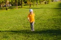 Cute boy running across grass und smiling Royalty Free Stock Photo