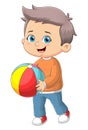 The cute boy is running and playing the rainbow ball Royalty Free Stock Photo