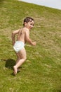 Cute boy running up hill Royalty Free Stock Photo