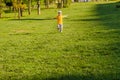 Cute boy running across grass und smiling Royalty Free Stock Photo