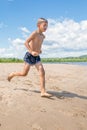 A boy jumps into the water in the river Royalty Free Stock Photo
