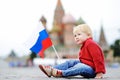Cute boy with russian flag with Red Square and Vasilevsky descent on background Royalty Free Stock Photo