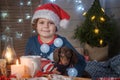 Cute boy in santa hat and dachshund puppy