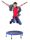 Cute boy with scarf exercising and jumping on a trampoline