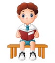 Cute boy in a school uniform reading a book Royalty Free Stock Photo