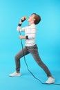 Cute boy singing in microphone on background Royalty Free Stock Photo