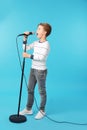 Cute boy singing in microphone Royalty Free Stock Photo