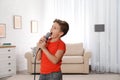 Cute boy singing in microphone Royalty Free Stock Photo