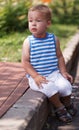 Cute boy sitting on the curb Royalty Free Stock Photo