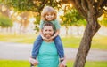 Cute boy sitting on fathers shoulders. Childhood and parenthood kids concept. Happy father and son playing together Royalty Free Stock Photo