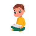 Cute Boy Sitting on Floor with Crossed Legs and Reading Book, Preschooler Kid or Elementary School Student Enjoying