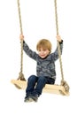 Cute boy sitting on rope swing Royalty Free Stock Photo
