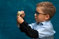 Cute boy sitting at the table and counting money Royalty Free Stock Photo