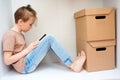 Cute boy sitting in the wardrobe and reading a book. Lifestyle, leisure and home education Royalty Free Stock Photo