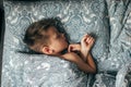 Cute boy sleeping in bed. Child 6-7 years old smiling, having a good dreams