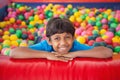 Cute boy smiling in ball pool Royalty Free Stock Photo