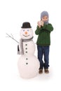 Cute boy with snowman with scarf and hat