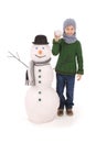 Cute boy with snowman with scarf and hat