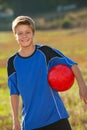 Cute boy with soccer ball outdoors.