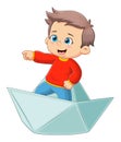 The cute boy is standing and pointing something on the paper boat Royalty Free Stock Photo