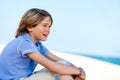 Cute boy staring at sea. Royalty Free Stock Photo