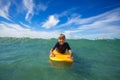 Cute boy swim on surf board smiling and looking at camera Royalty Free Stock Photo