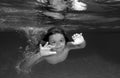 Cute boy swimming underwater in shallow turquoise water at tropical beach. Child swim and dive underwater in the Royalty Free Stock Photo