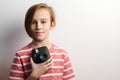 Cute boy taking selfe with photo camera. Stylish kid over grey background Royalty Free Stock Photo