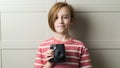 Cute boy taking selfe with photo camera. Stylish kid over grey background Royalty Free Stock Photo